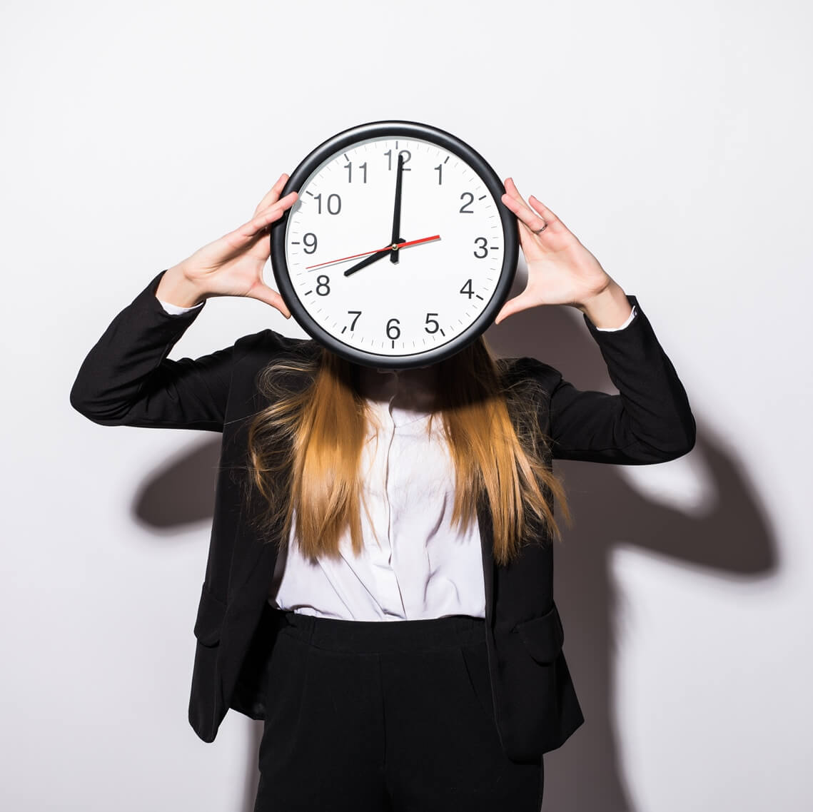 woman holding a clock